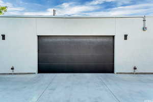Garage featuring concrete driveway