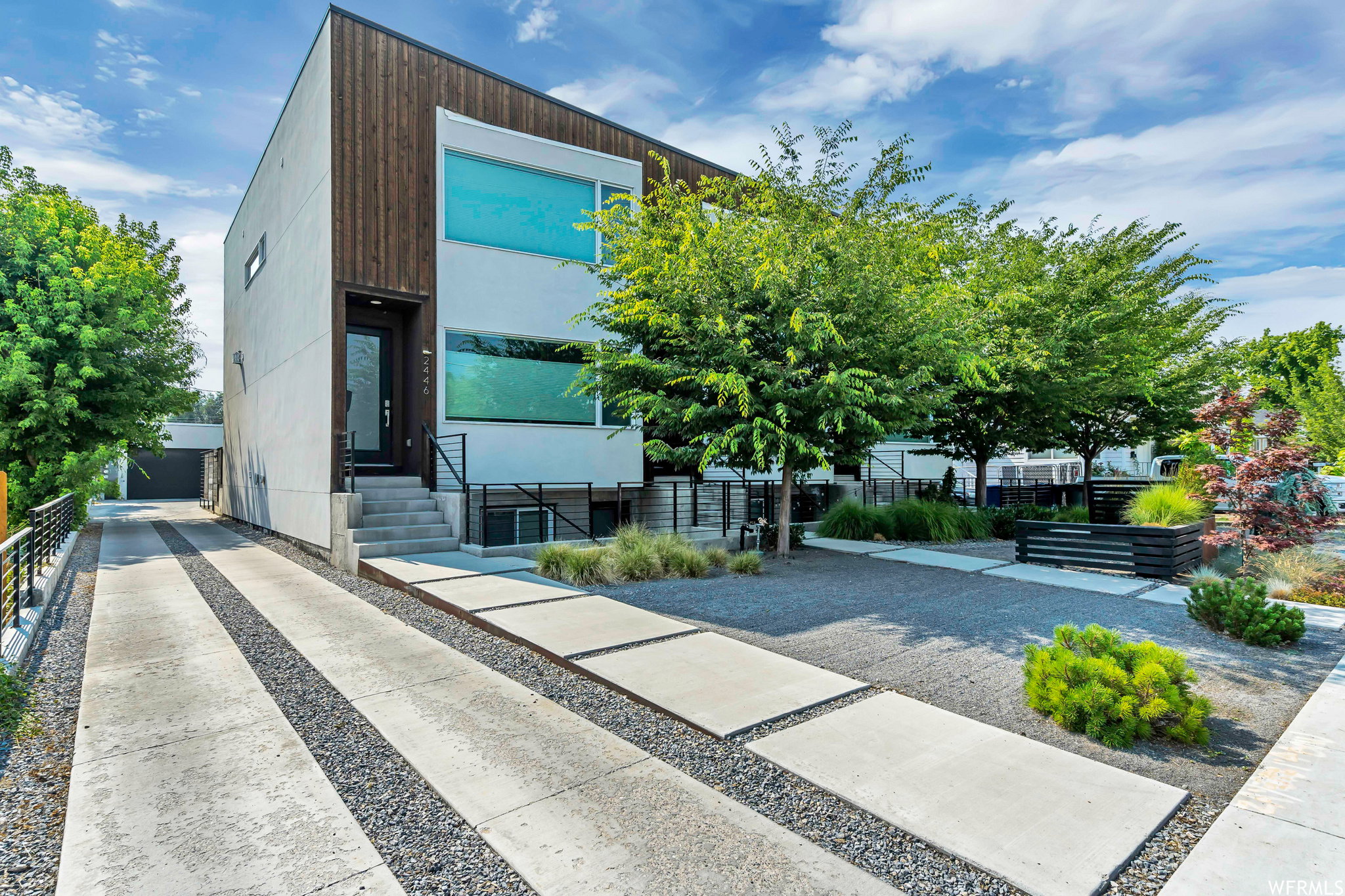 View of building exterior showing the driveway that leads to the garage.