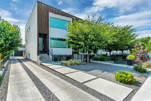 View of building exterior showing the driveway that leads to the garage.