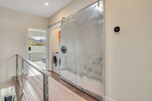 Bathroom with dark wood-style flooring and recessed lighting