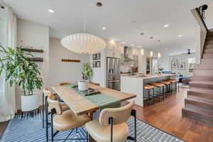 Dining area with dark wood-style floors and recessed lighting