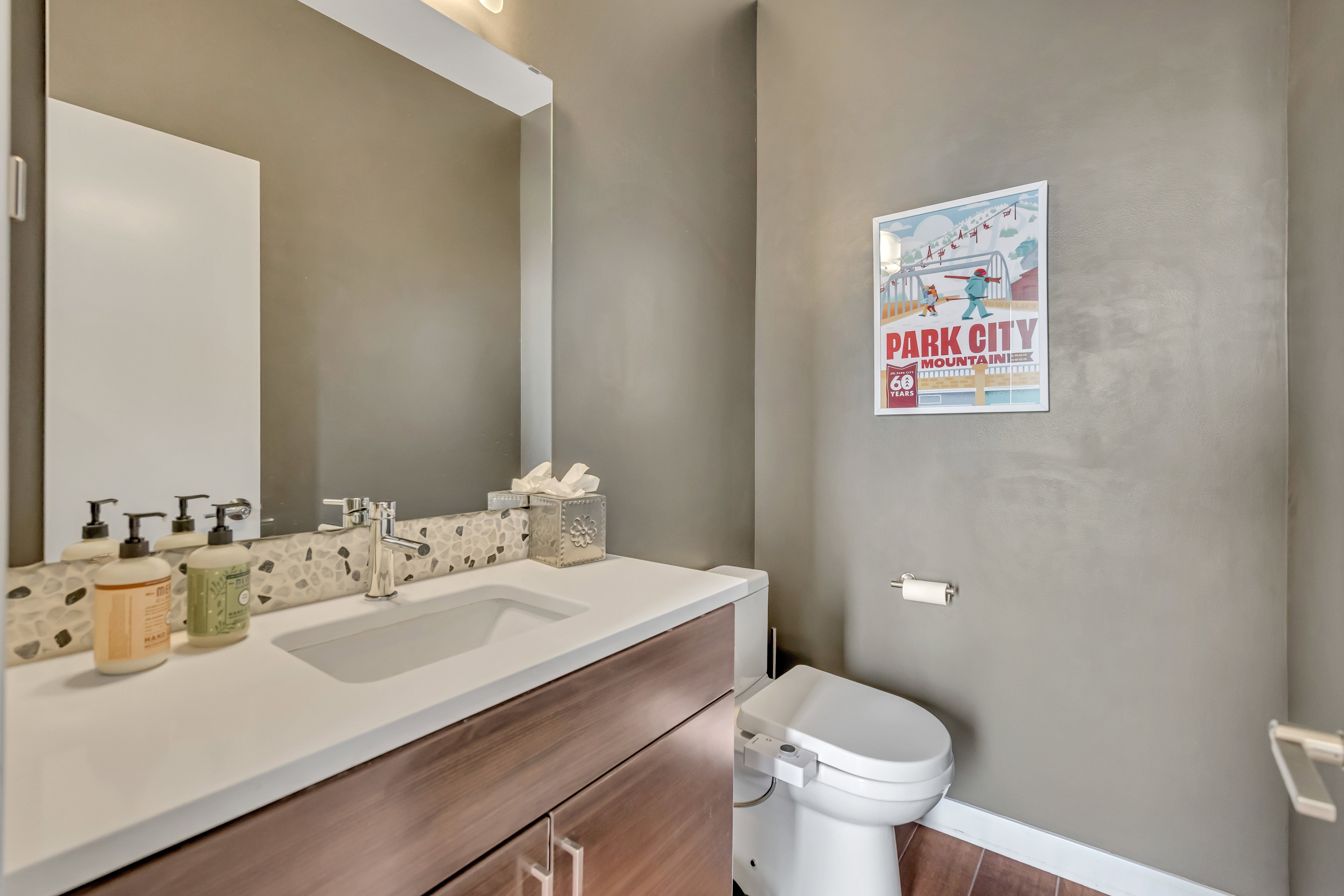 Half bath with baseboards and vanity located on the main level