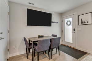 Dining area featuring baseboards and concrete floors
