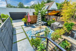 View of patio / terrace featuring area for grilling, a pergola, and the garage