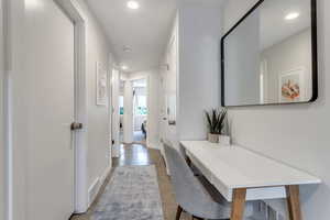 Corridor with recessed lighting and concrete flooring