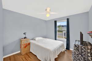 Bedroom with light wood-type flooring and ceiling fan