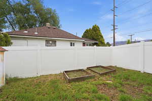 Fenced backyard with a garden
