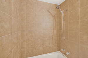 Bathroom featuring washtub / shower combination