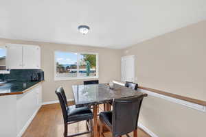 Dining room featuring light wood-type flooring and baseboards