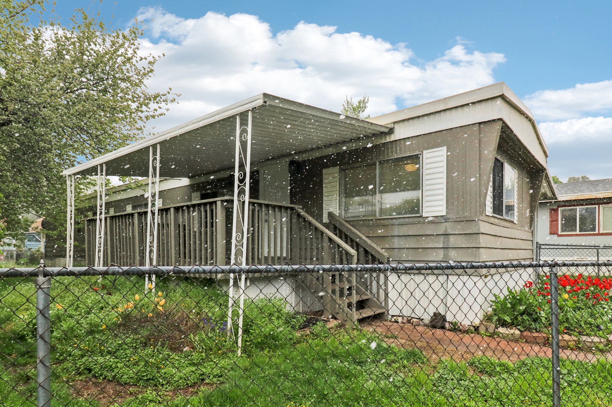 View of side of property with a wooden deck