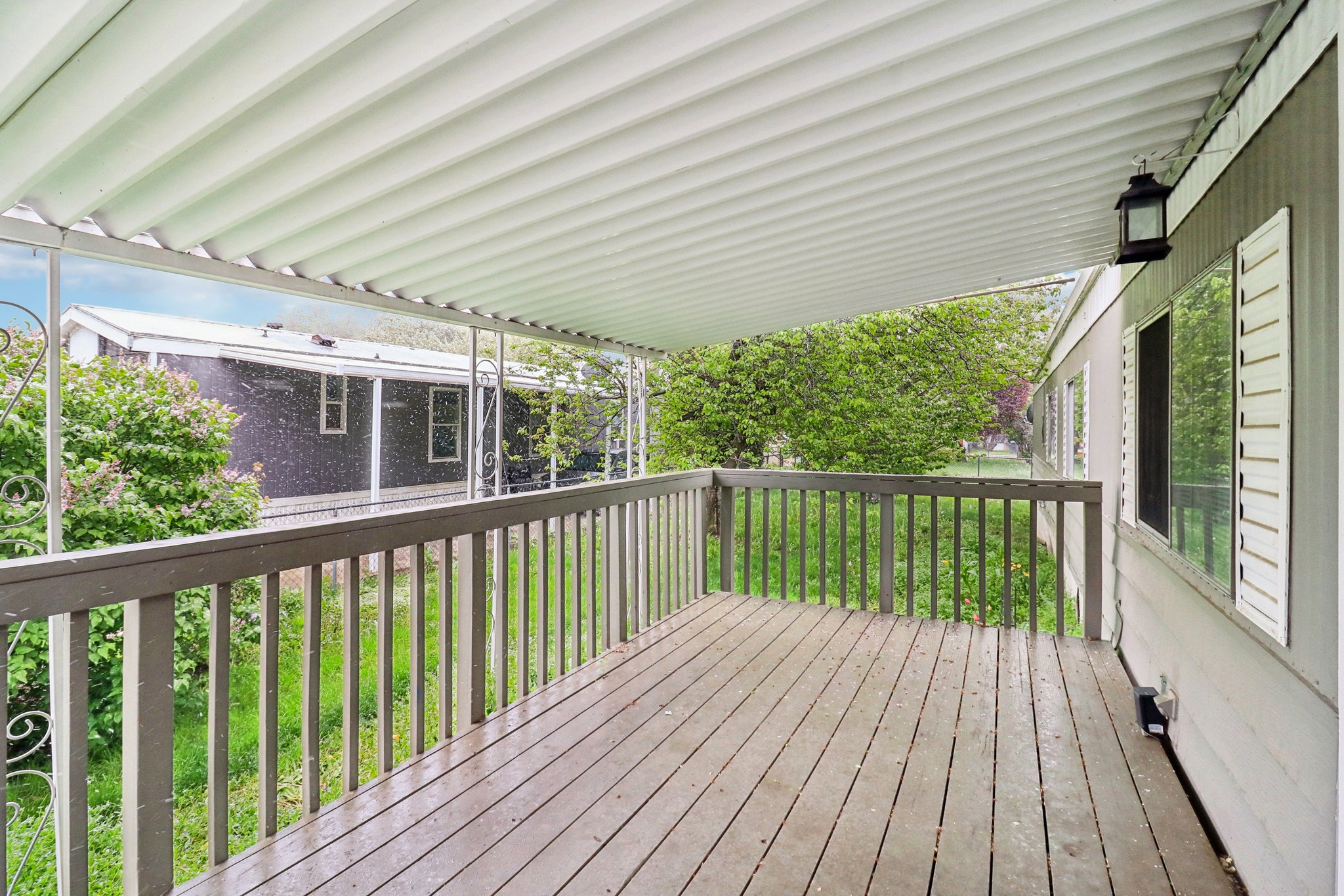 Wooden terrace featuring a lawn