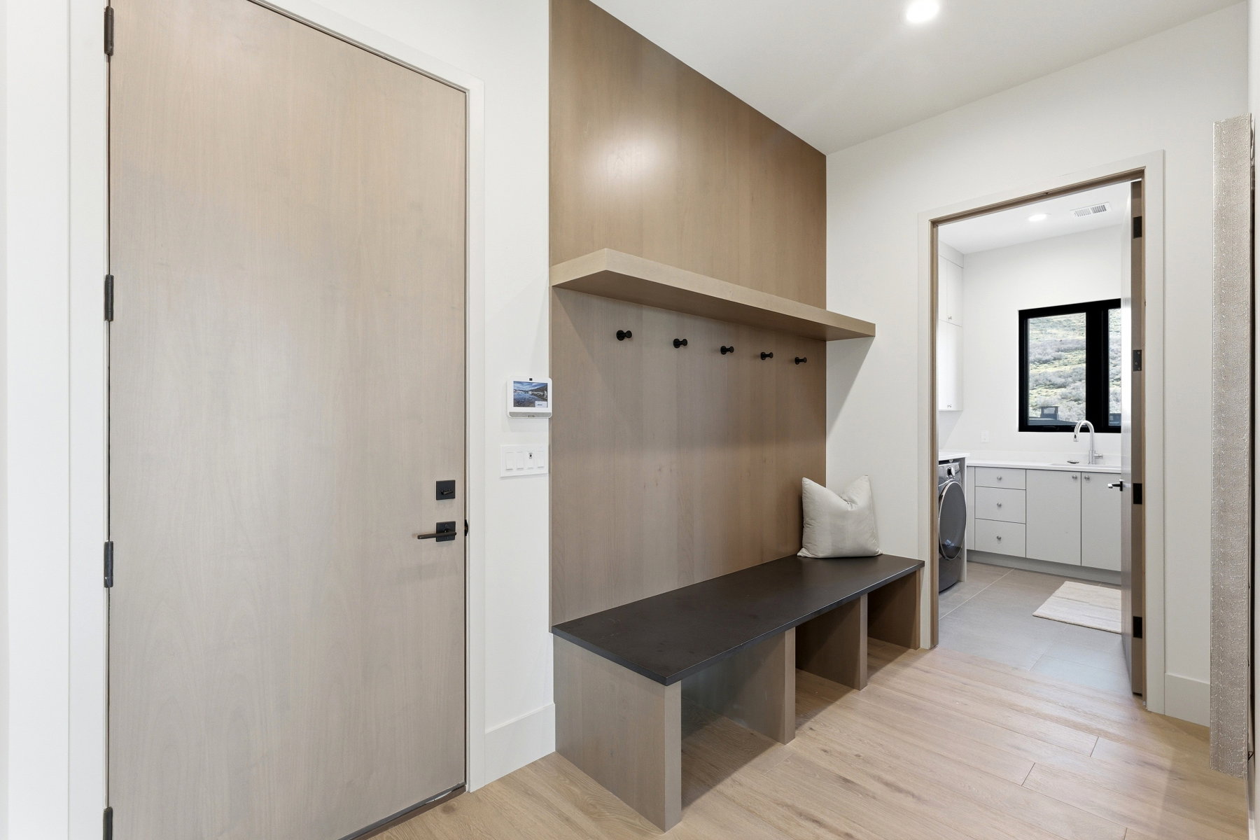 Mudroom featuring light wood-style flooring, recessed lighting, and washer / dryer