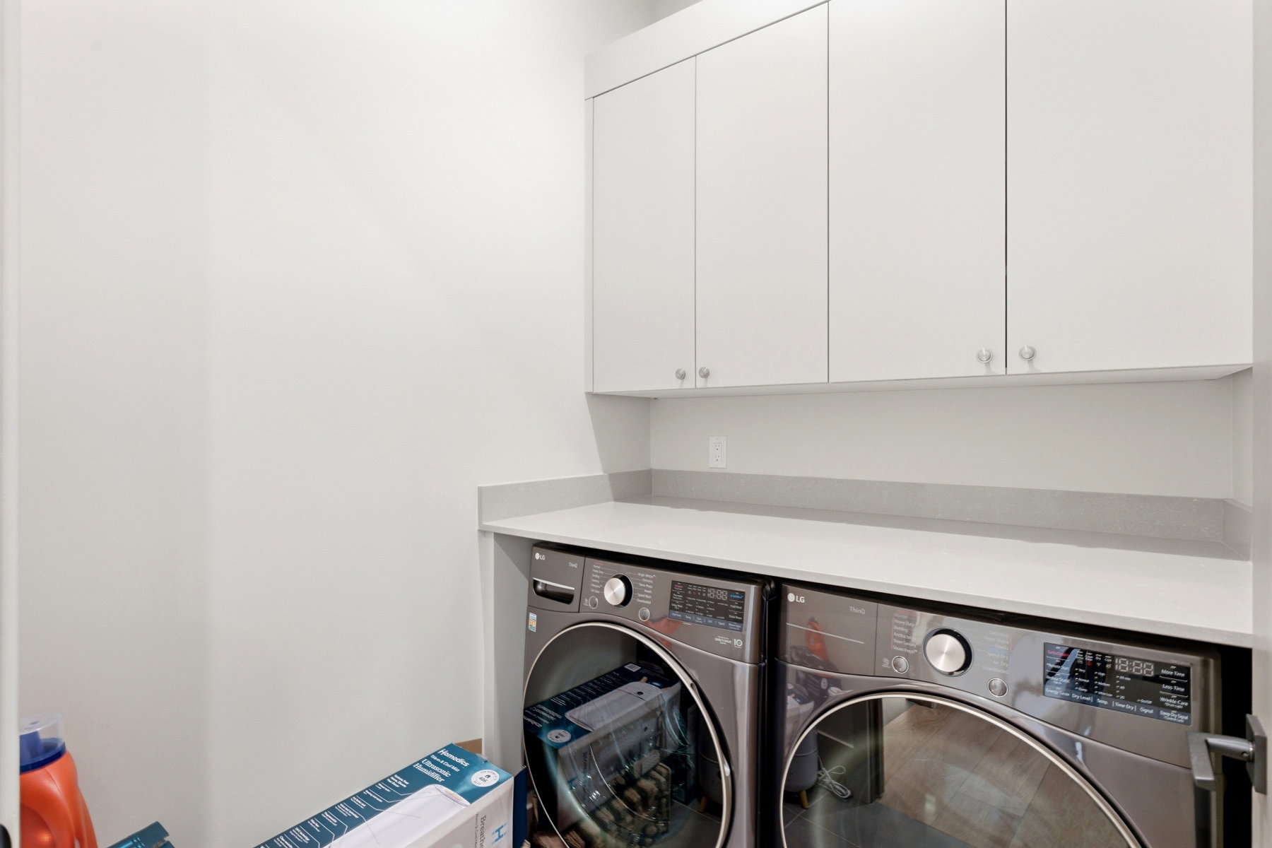 Laundry area with cabinet space and washer and clothes dryer