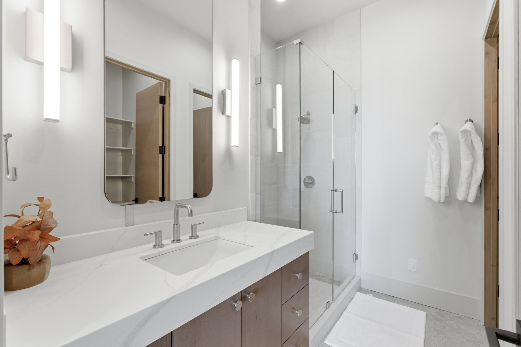 Bathroom featuring vanity and a shower stall