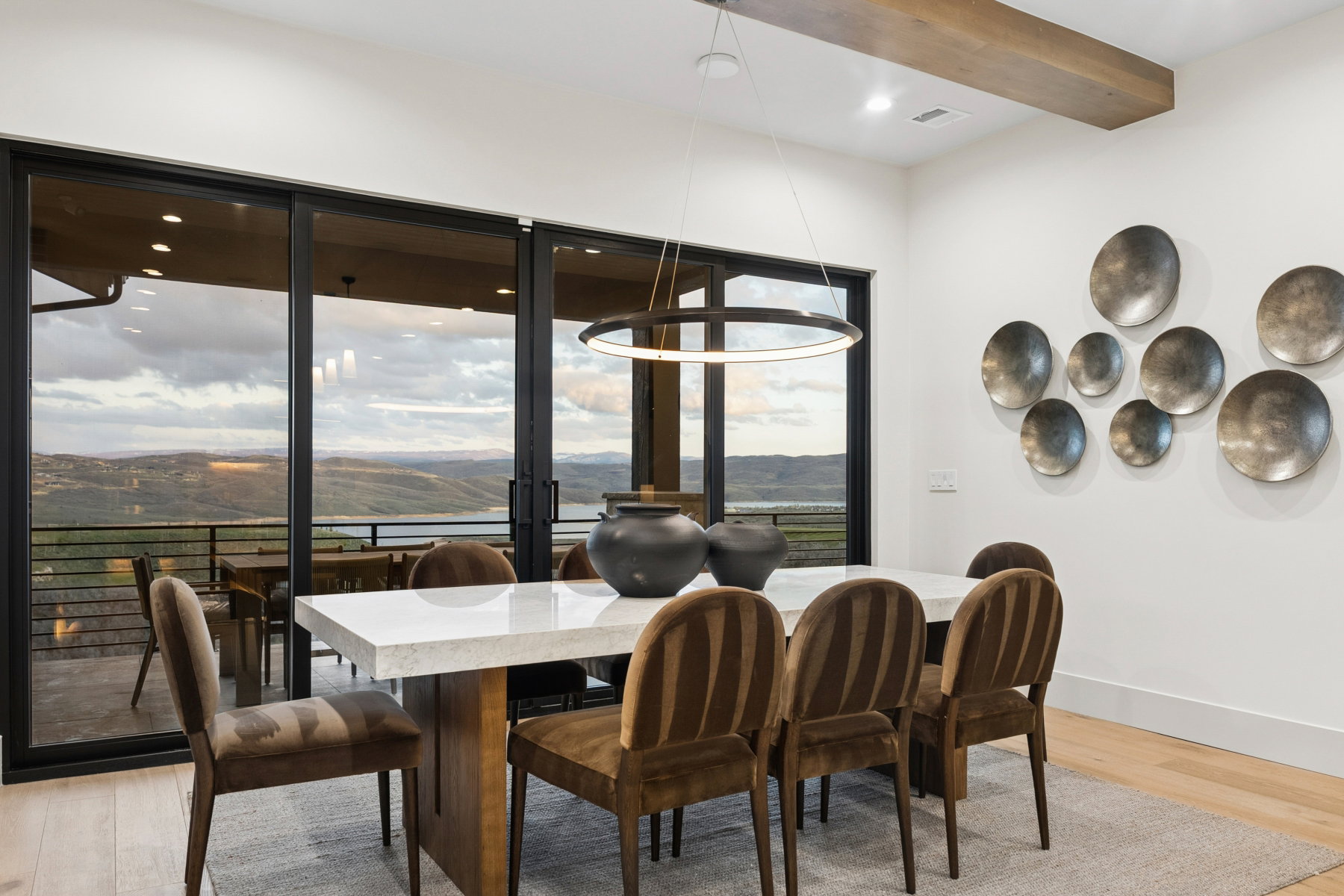 Dining room featuring a mountain view, light wood-style flooring, beamed ceiling, and recessed lighting