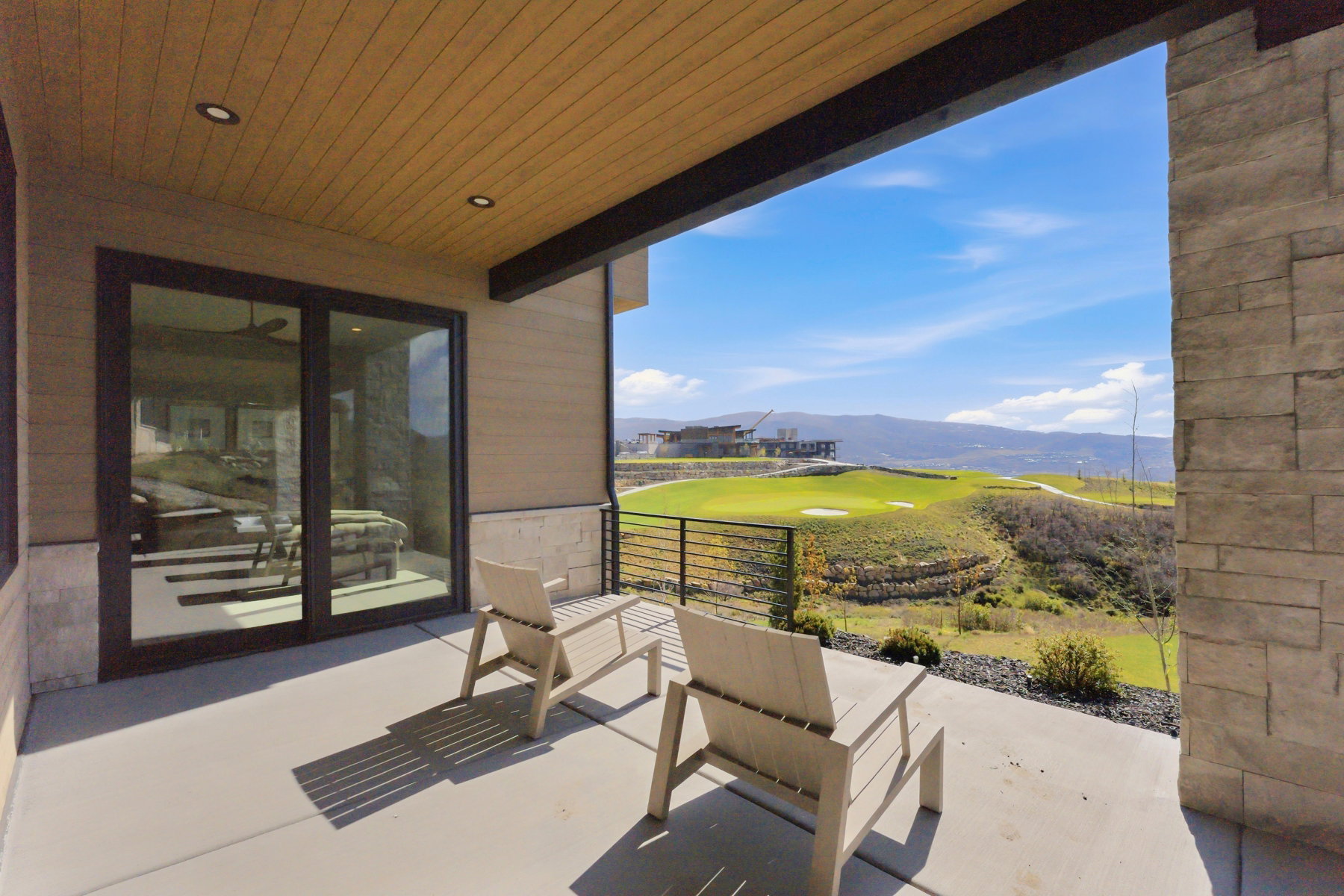 View of patio with a mountain view and golf course view