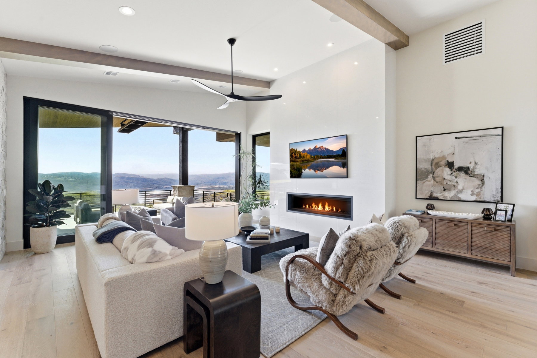 Living area featuring a lit fireplace, light wood finished floors, and recessed lighting