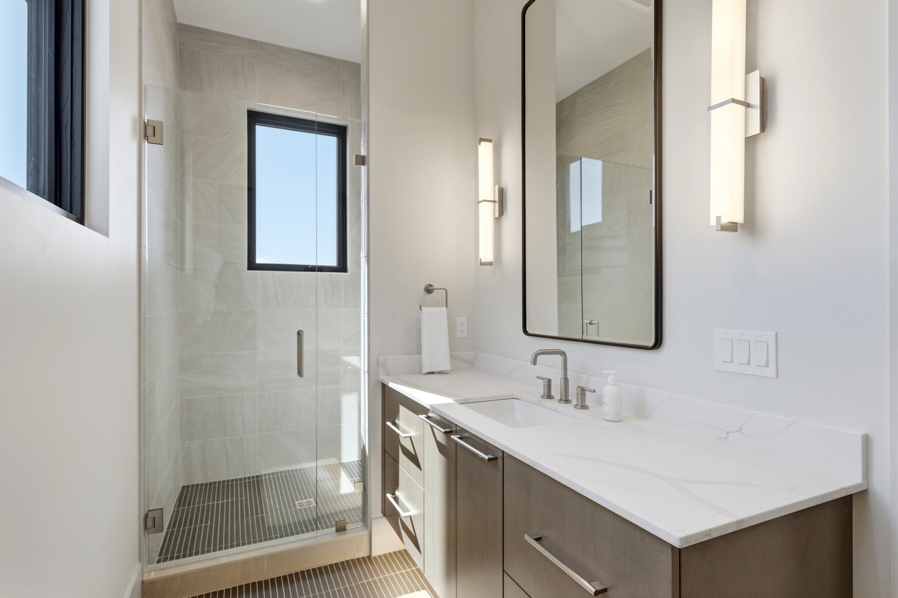 Full bathroom with vanity and a stall shower