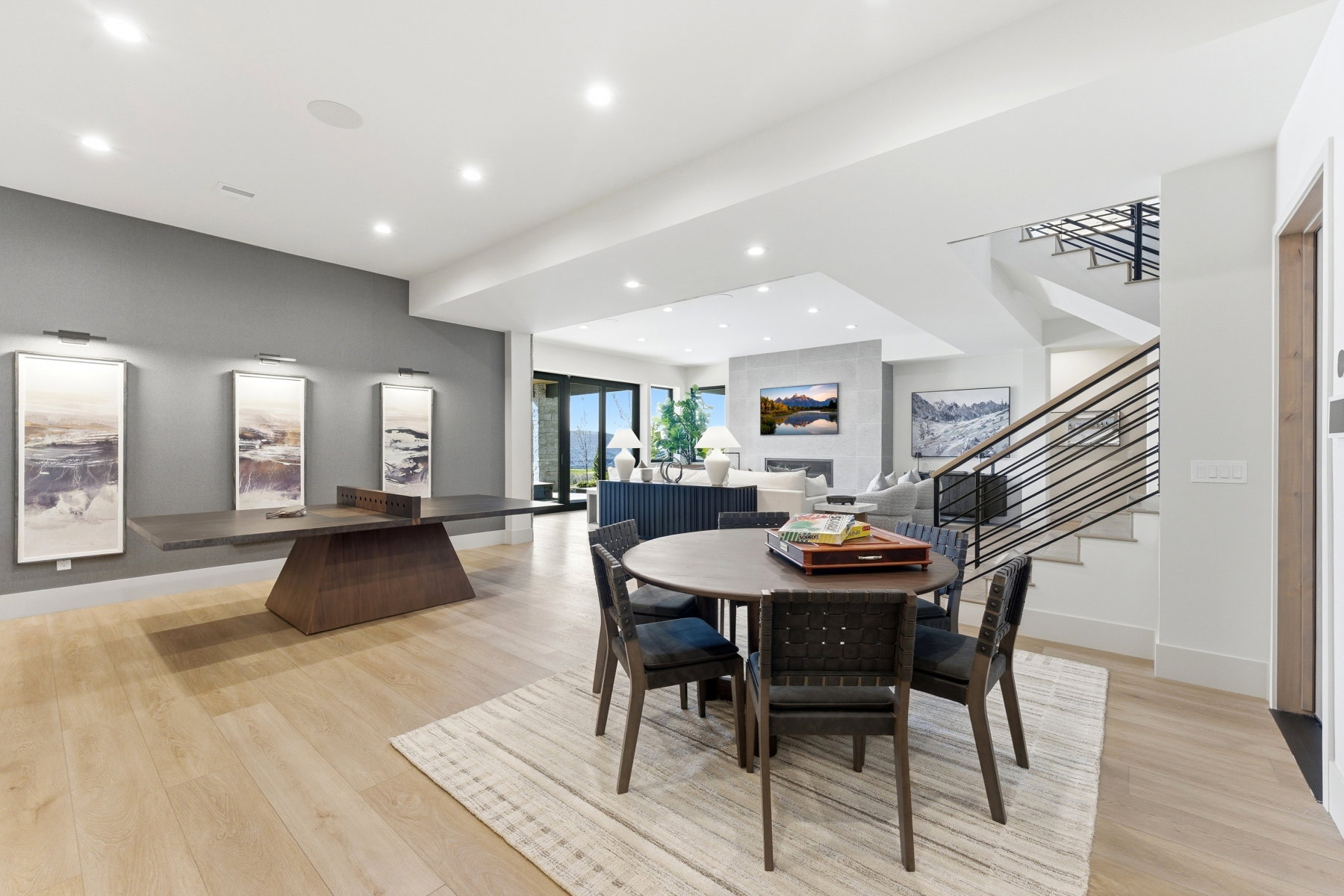 Dining room with light wood-style flooring and recessed lighting