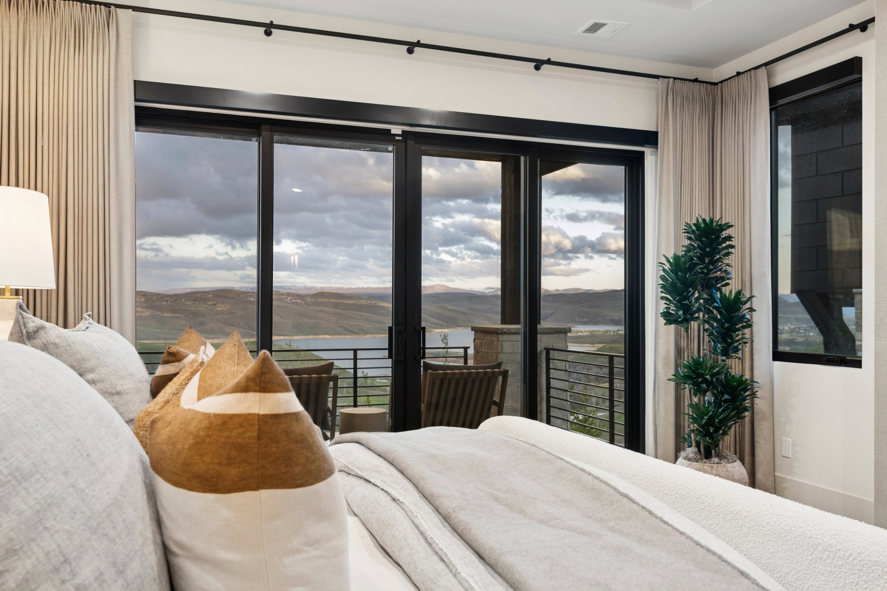 Bedroom featuring a mountain view, access to exterior, and multiple windows