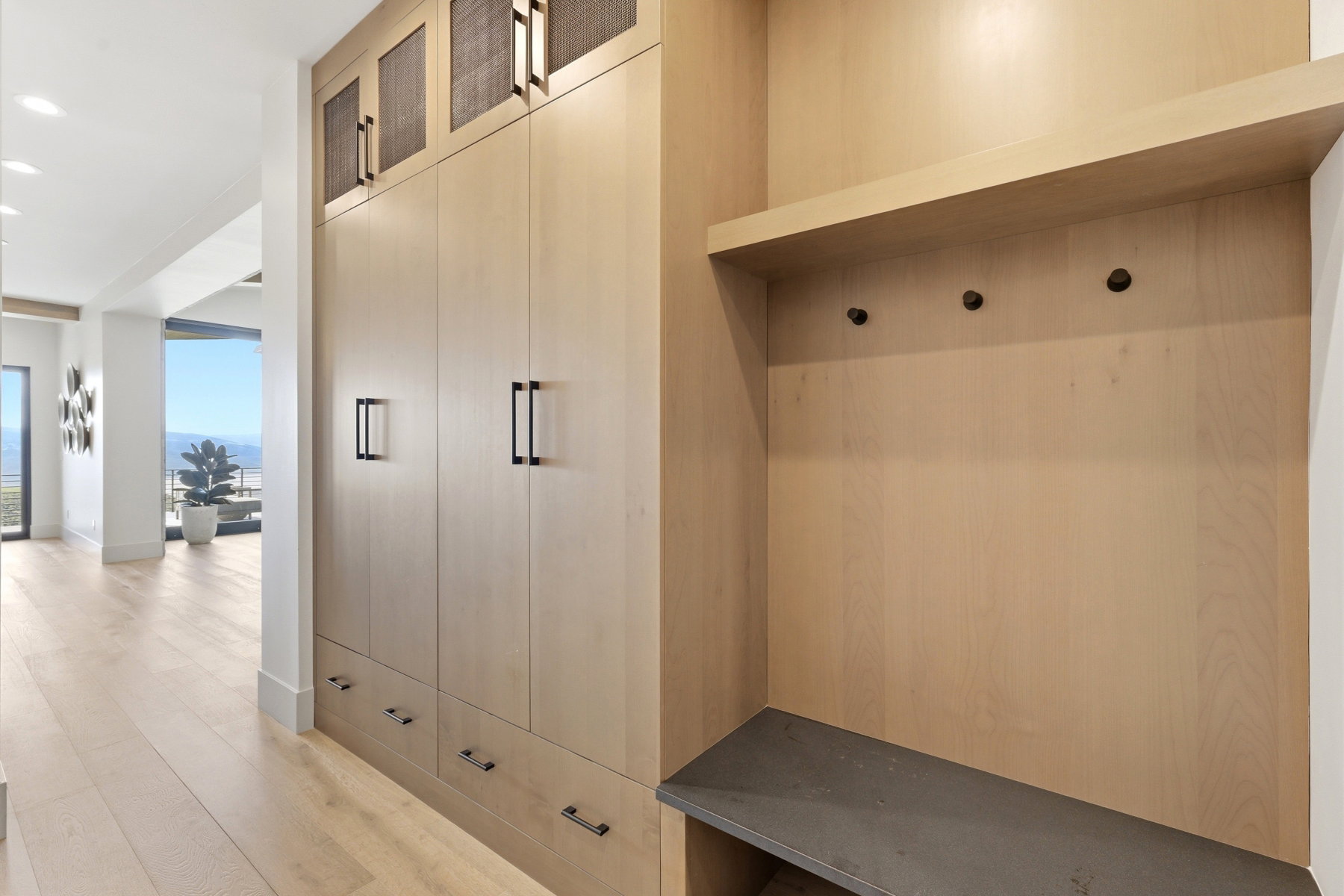 Mudroom featuring light wood finished floors and recessed lighting