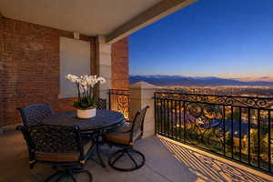 Balcony at dusk with outdoor dining space and a mountain view