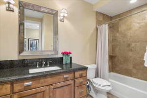 Full bath featuring vanity and shower / bath combination with curtain