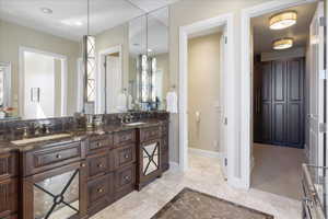 Bathroom with double vanity and recessed lighting