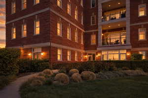 Rear view of property with a balcony and brick siding