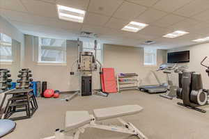 Workout area featuring a drop ceiling