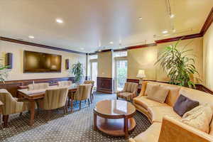 Common area featuring ornamental molding, wallpapered walls, recessed lighting, and a wainscoted wall