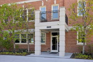 View of exterior entry with brick siding