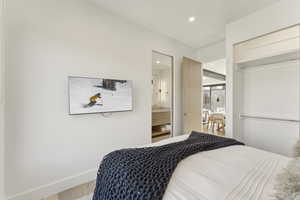 Bedroom featuring recessed lighting, wood finished floors, a closet, and ensuite bath