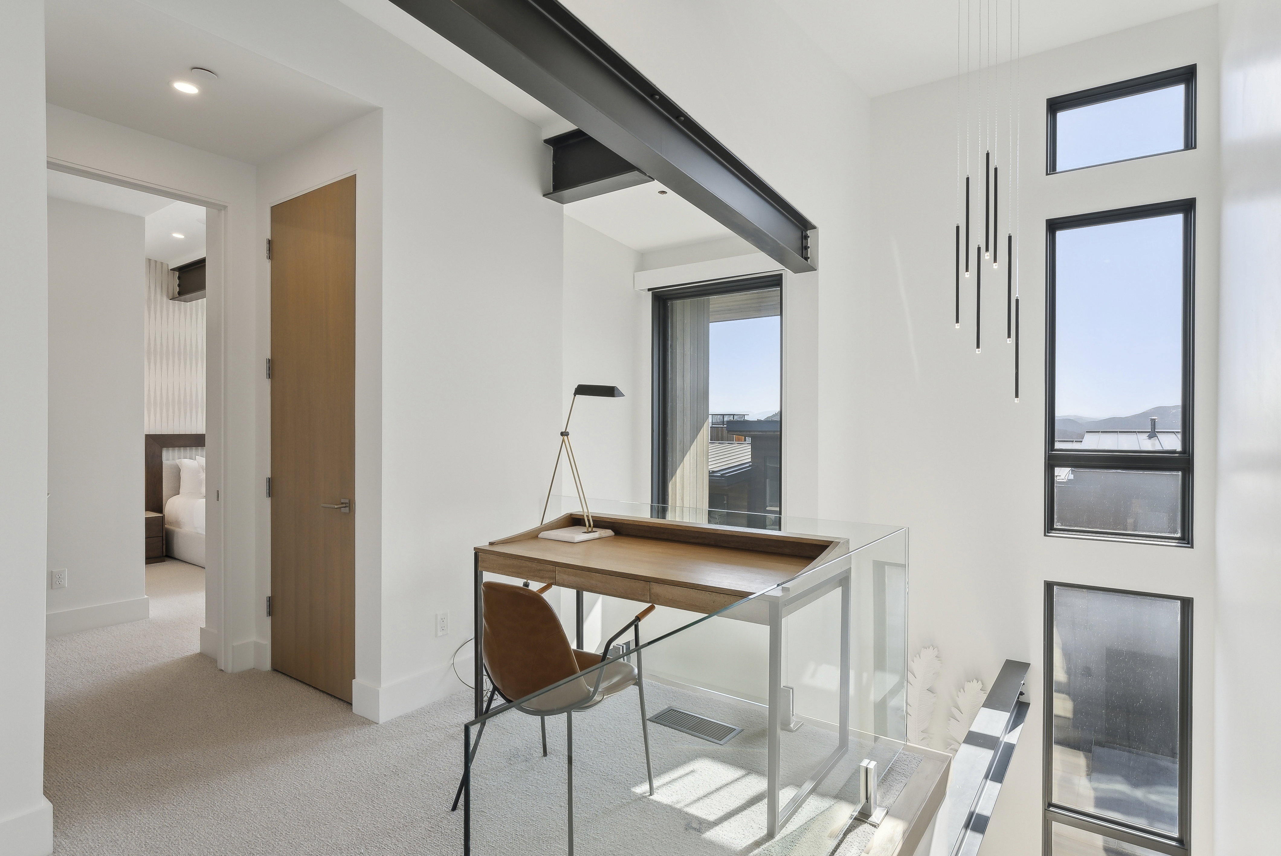 Home office with light carpet and baseboards