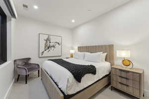 Bedroom featuring light carpet and recessed lighting