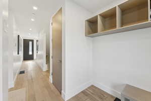 Mudroom with recessed lighting and light wood-style floors