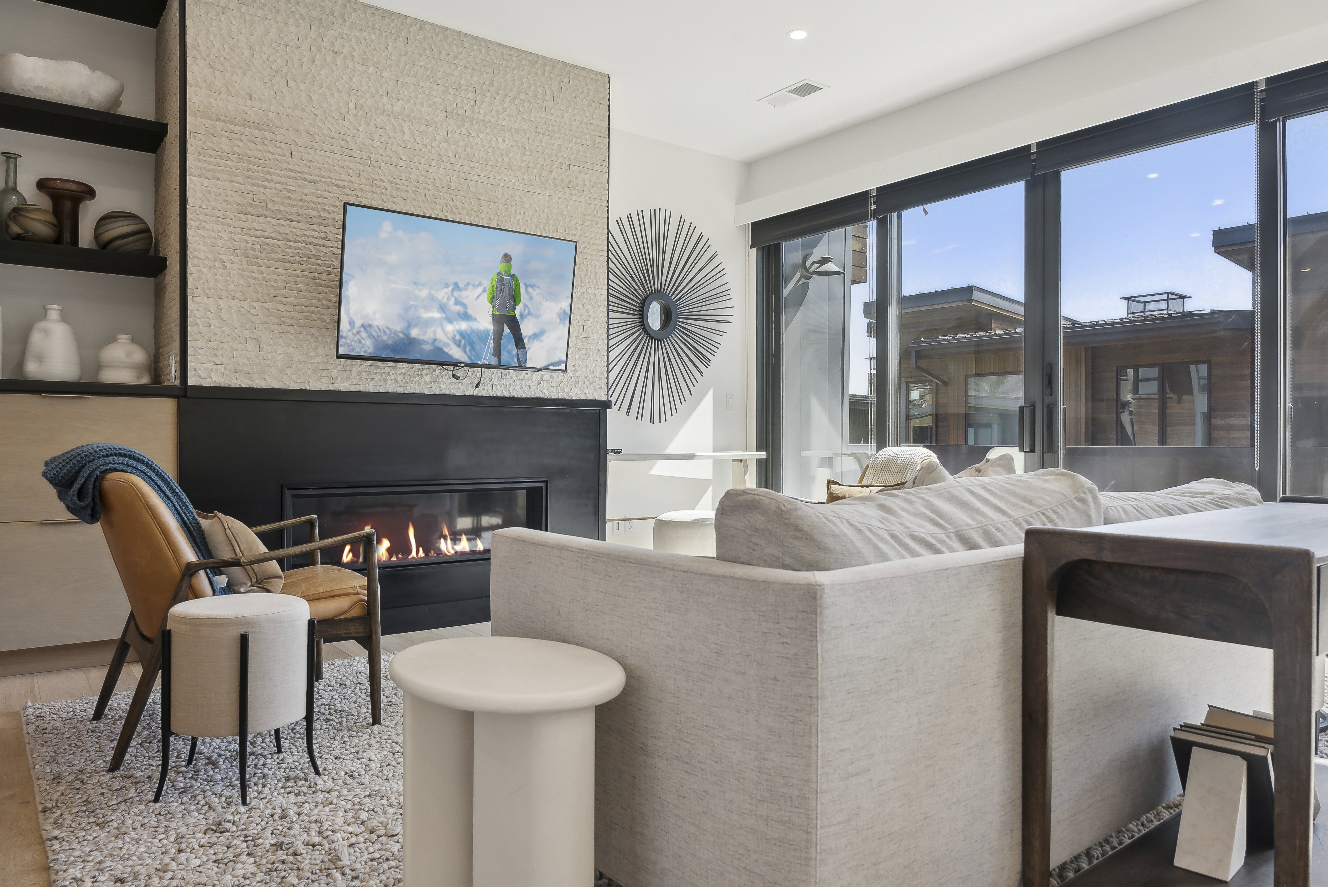 Living room with a glass covered fireplace, wood finished floors, and recessed lighting