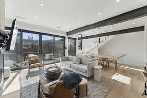 Living room featuring light wood finished floors and recessed lighting