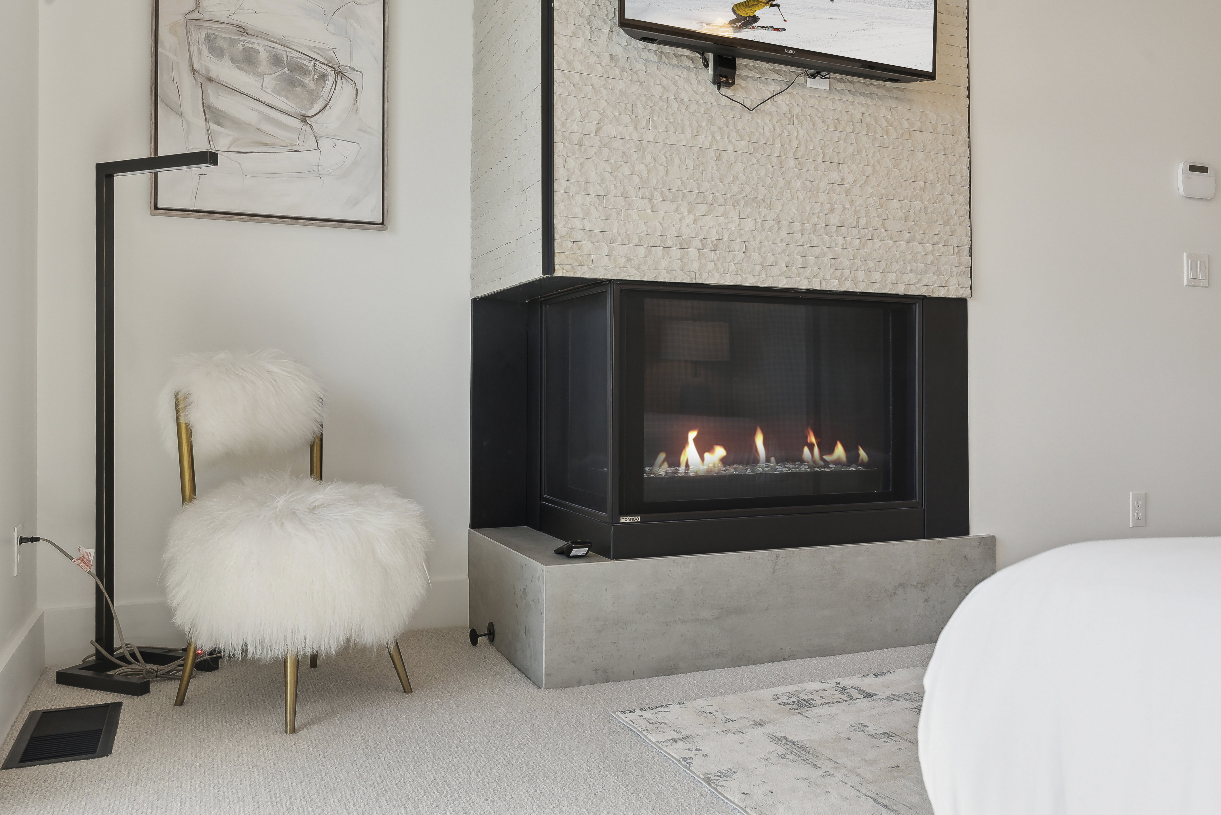 Detailed view of carpet flooring and a glass covered fireplace