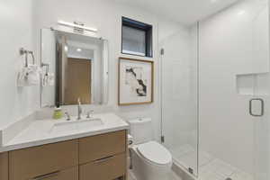 Bathroom featuring vanity, a shower stall, and recessed lighting