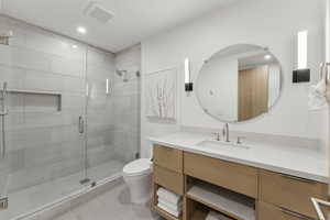 Full bath featuring vanity, a shower stall, light tile patterned floors, and recessed lighting