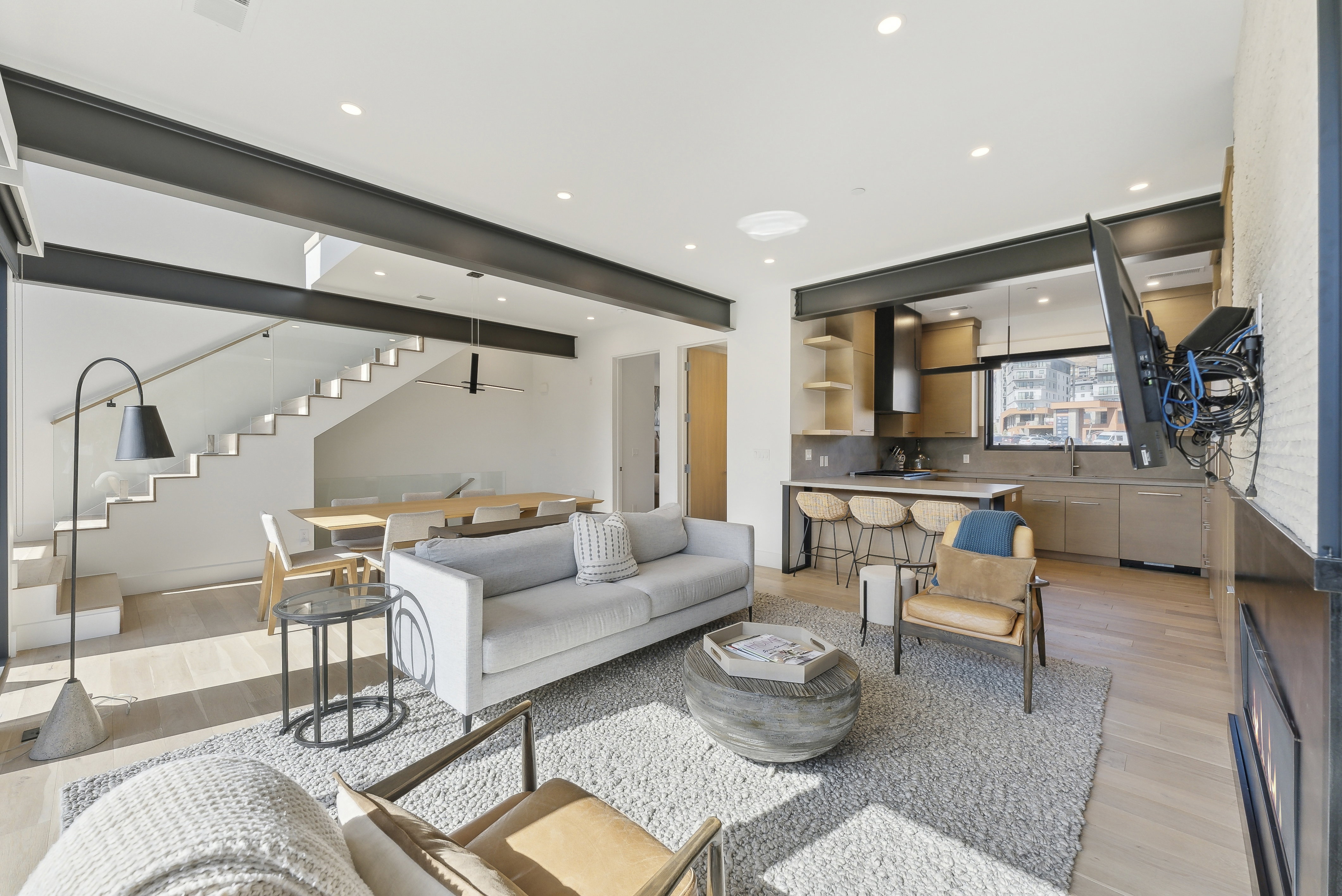 Living room with light wood finished floors and recessed lighting