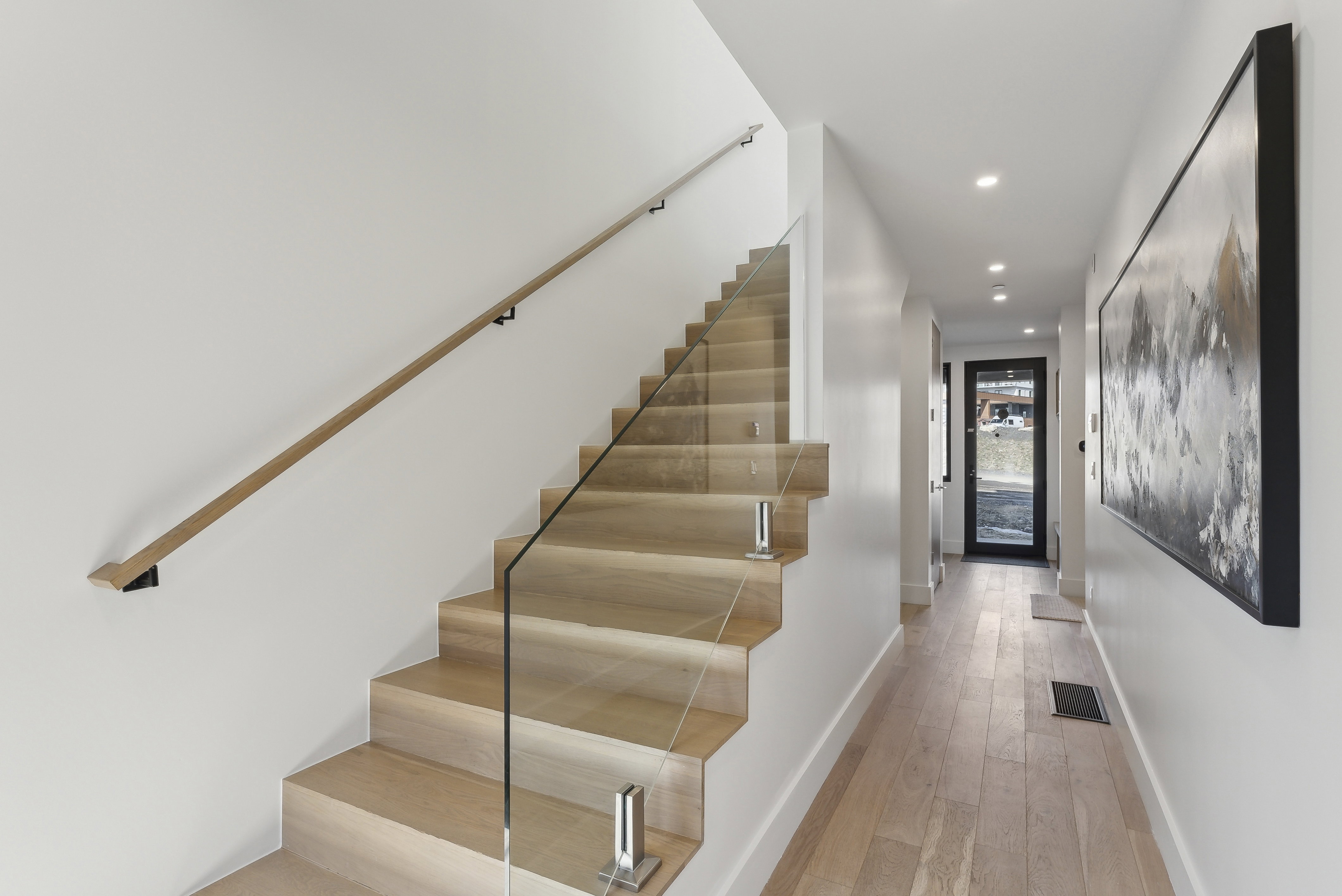 Stairway with hardwood / wood-style floors and recessed lighting