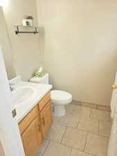 Half bathroom with vanity and light tile patterned floors new