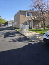 View of front facade with mailbox location, front lawn, and stucco siding