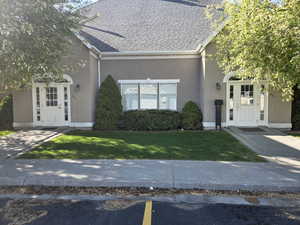 View of front of the clubhouse with stucco siding,