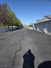 View of asphalt road with community garages and a residential view