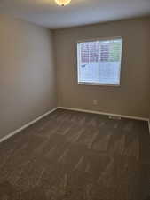Spare room featuring carpet