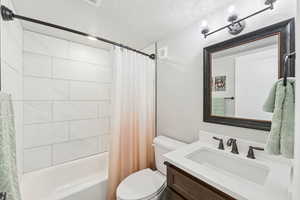 ADU hall bath with vanity and shower / tub combo with curtain