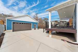 View of detached garage, back deck and extra parking